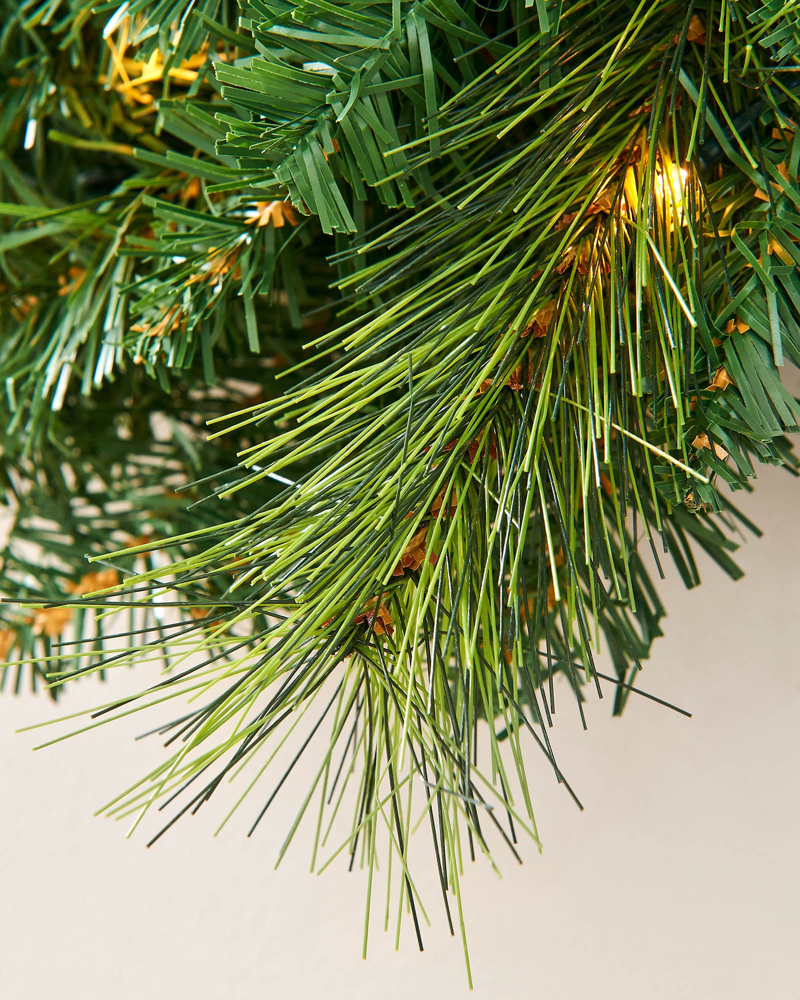 Close-up of mixed green pine-style foliage on a 60 cm Christmas wreath