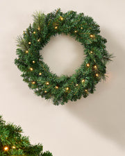 60 cm green pre-lit Christmas wreath with warm white LEDs displayed on a wall