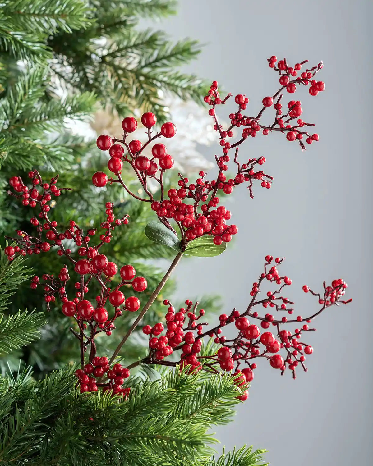 62 cm red artificial berries tree pick styled in a Christmas tree