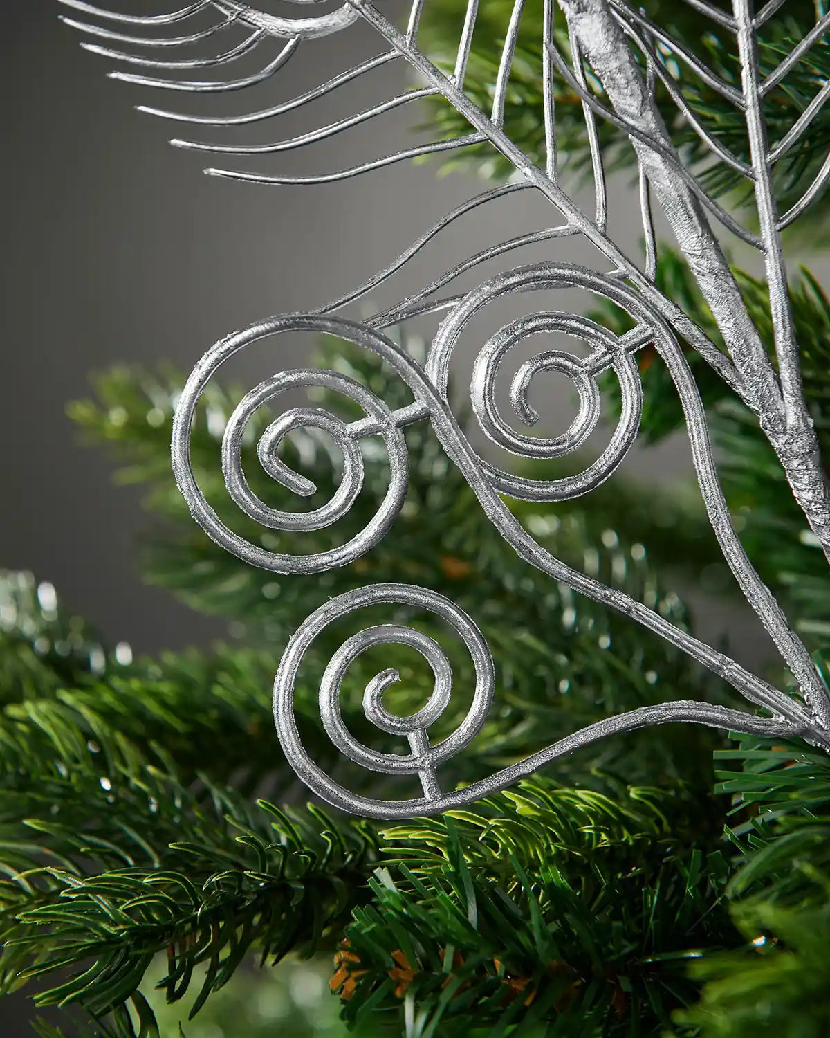 Close-up of the silver swirl detailing on the 62 cm artificial feather pick