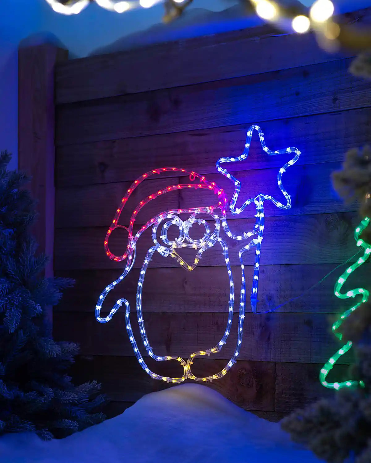 64 cm pre-lit penguin and star silhouette in an outdoor festive scene