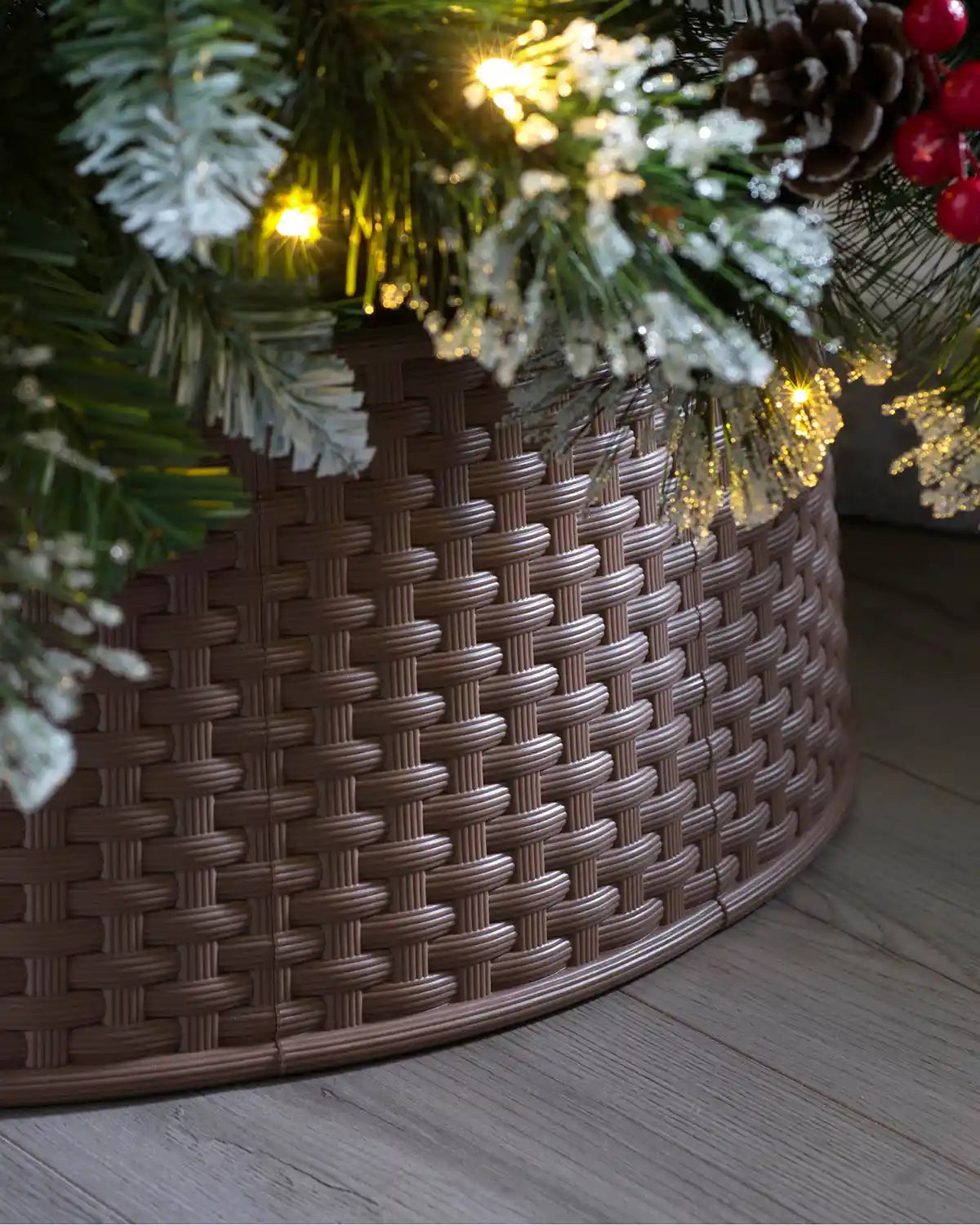 Brown 65 cm rattan effect tree collar displayed under a Christmas tree