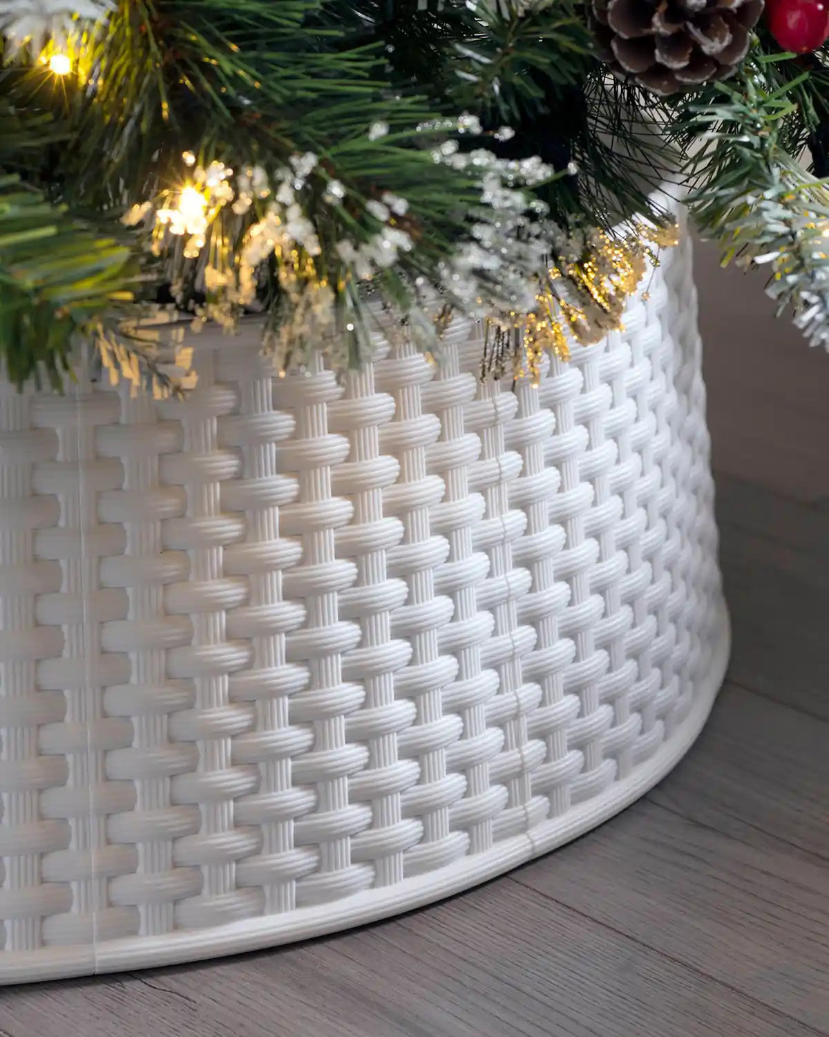 White 65 cm rattan effect tree collar displayed under a Christmas tree