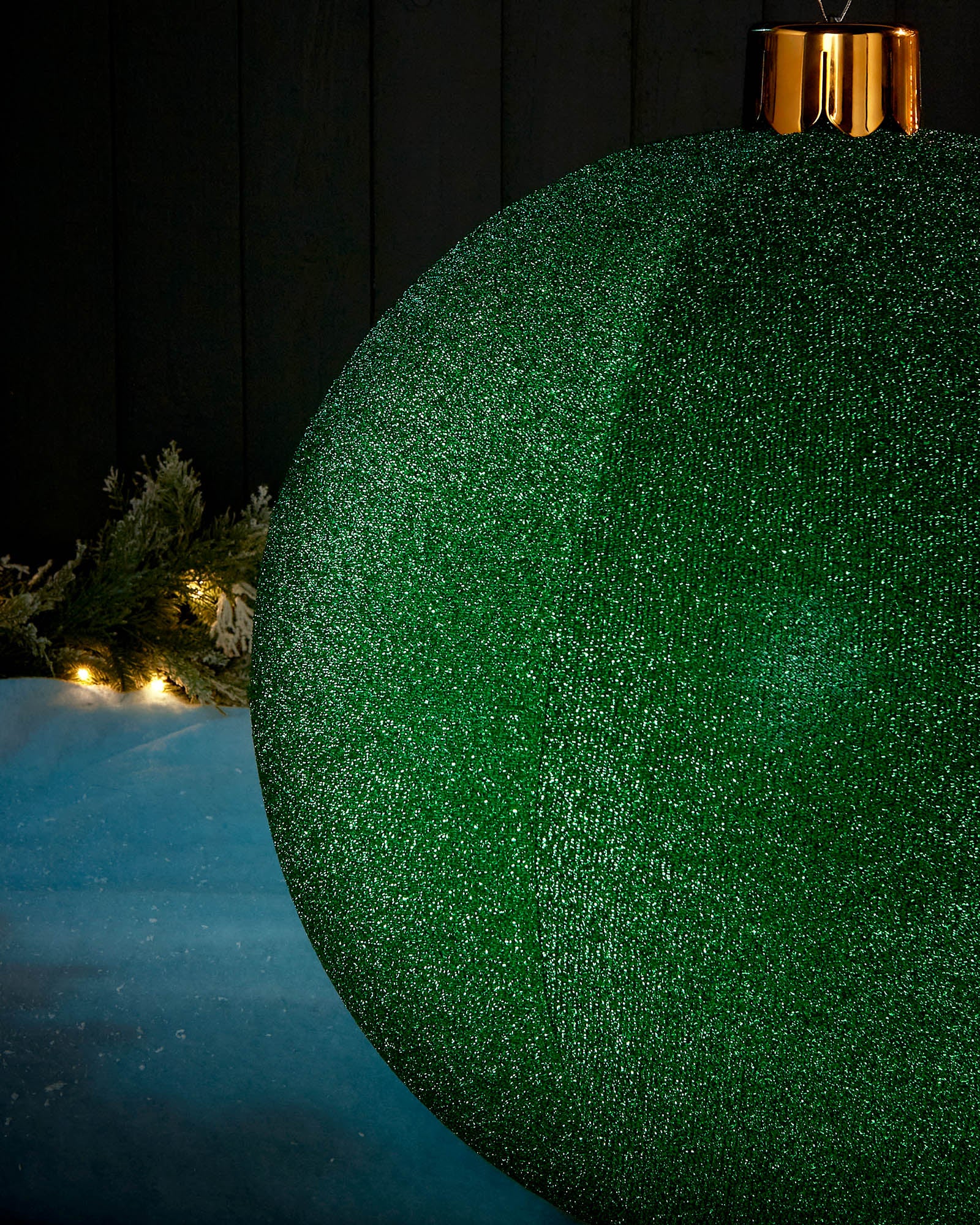 Detail close-up of the textured green tinsel surface on a 66cm inflatable Christmas bauble.