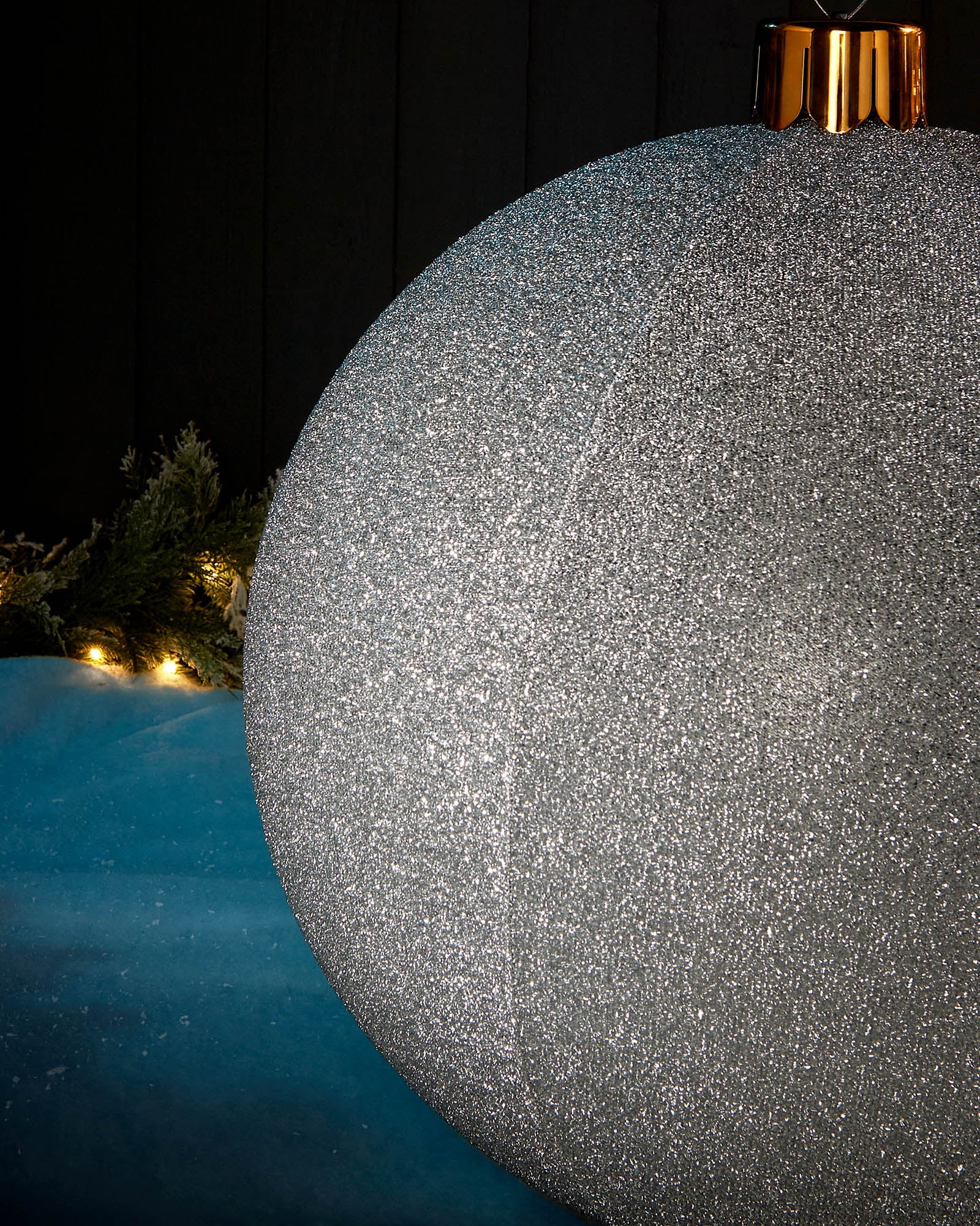 Detail close-up of the textured silver tinsel surface on a 66cm inflatable Christmas bauble.