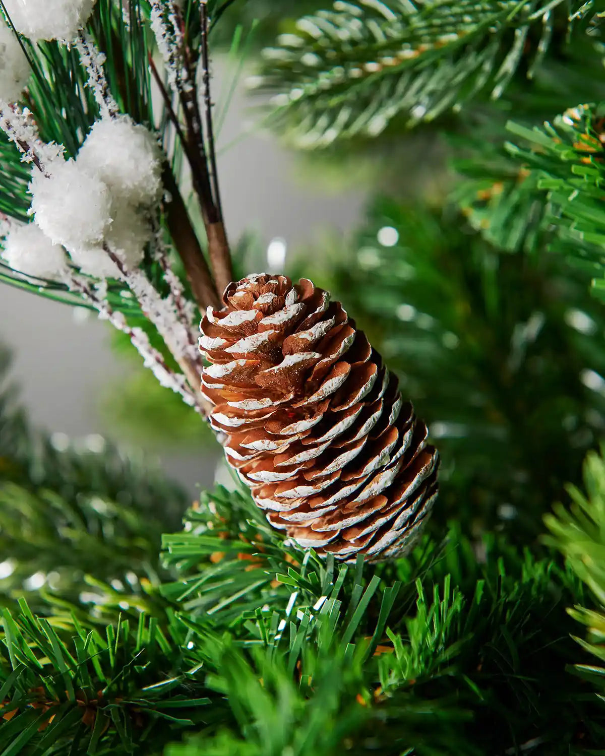 Close-up of the pine cone detail on the 66 cm white artificial berries pick