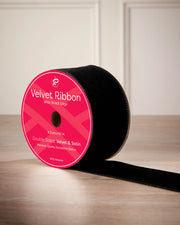 6 cm black velvet ribbon on a spool with wired edge and 9 m length shown on the label.