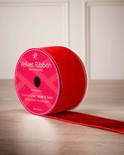 6 cm red velvet ribbon on a spool with wired edge and 9 m length shown on the label.