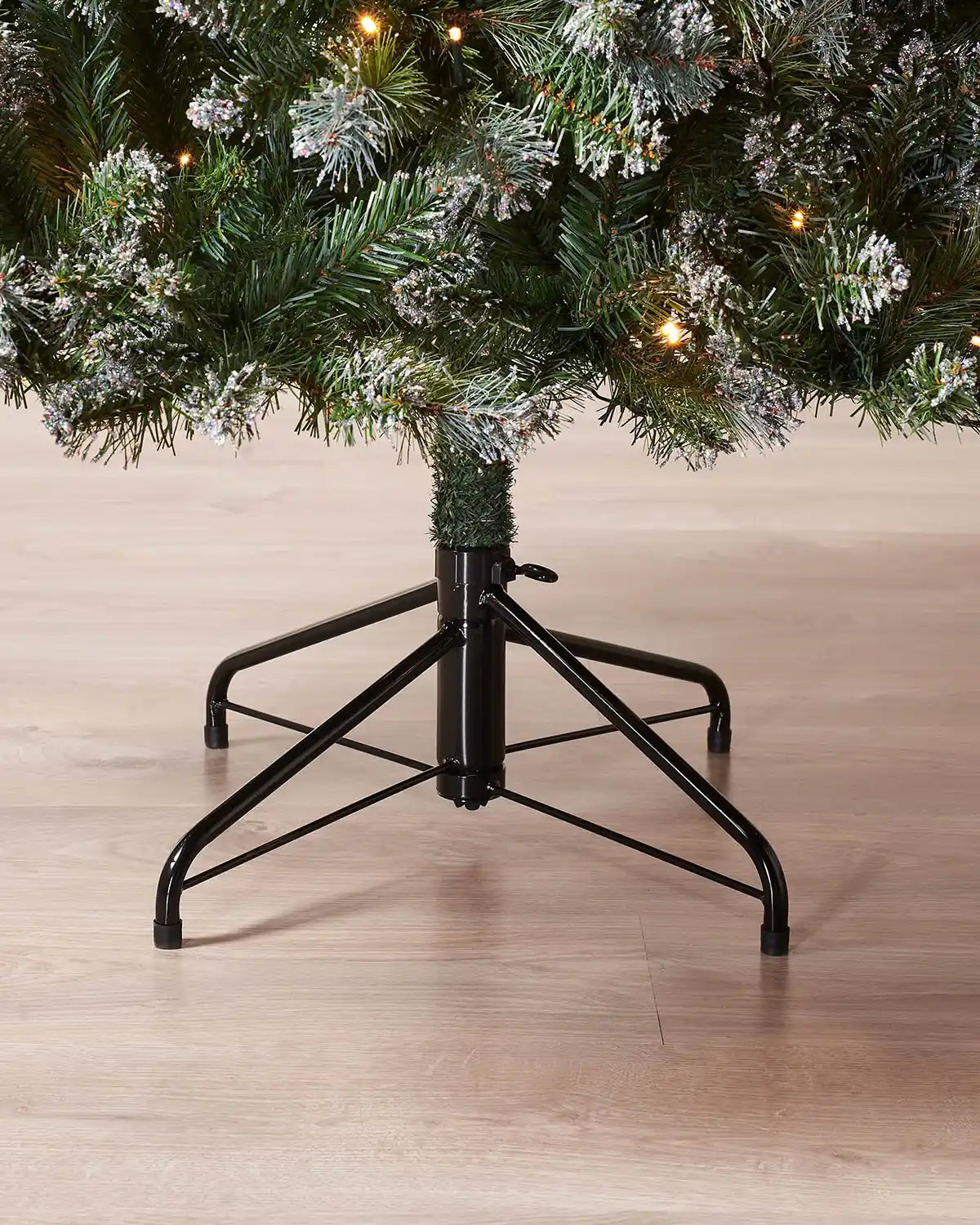 Close-up of the foldable metal stand on the 6 ft Blue Brockton Spruce Christmas tree
