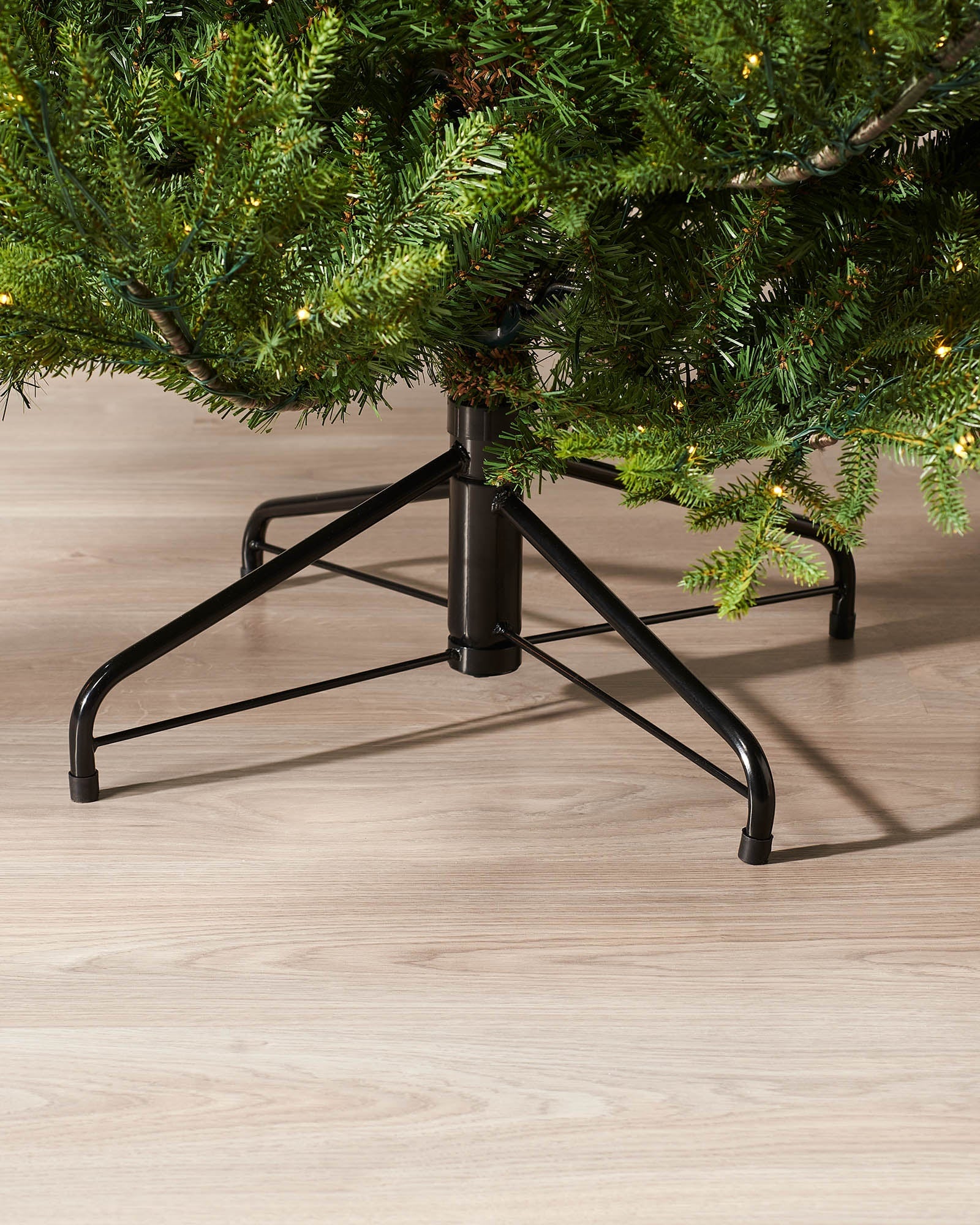 Black Metal stand detail of 6 ft pre-lit Douglas fir Christmas tree