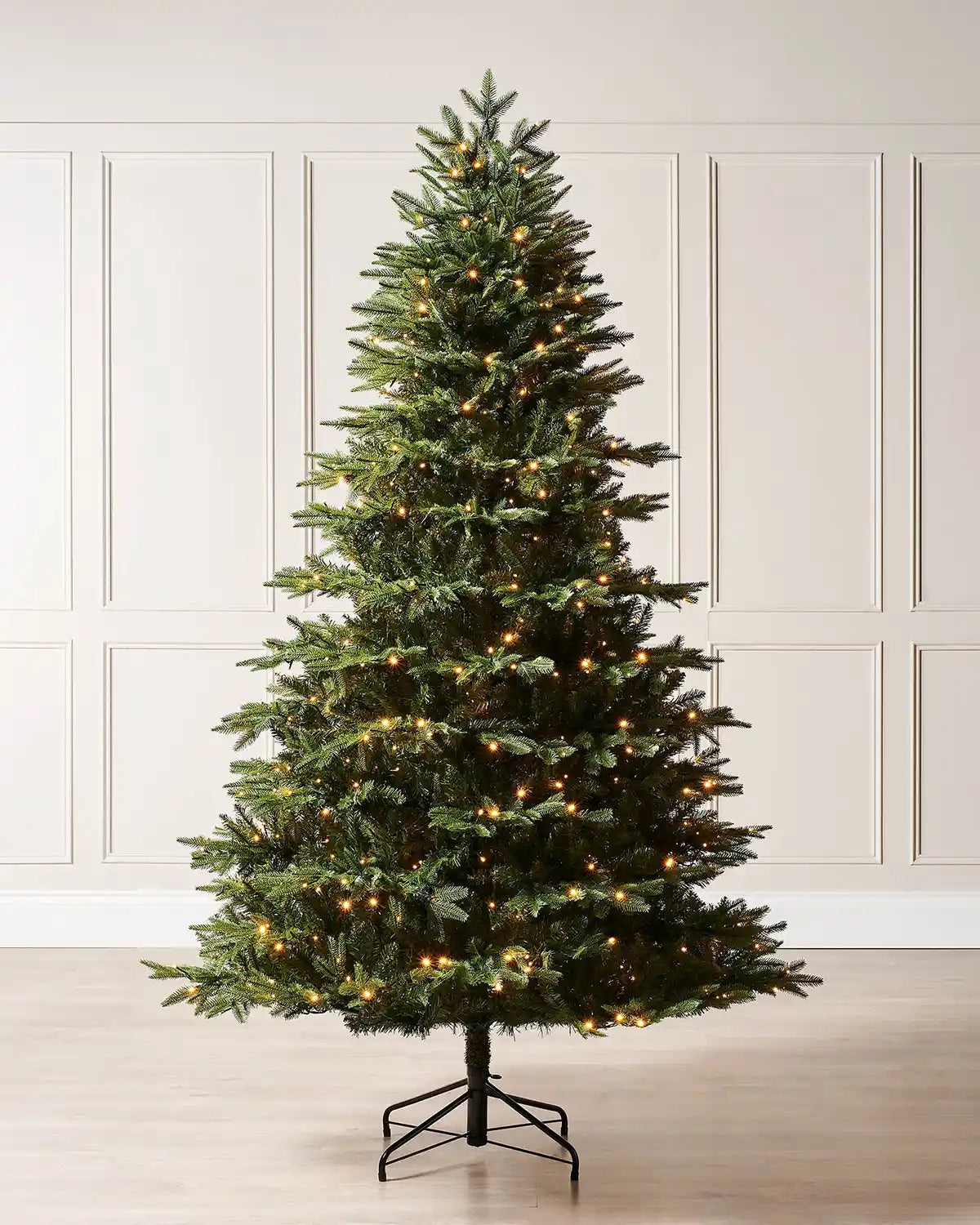 6ft pre-lit Royal Fir Christmas tree with warm white lights displayed indoors against wall panelling