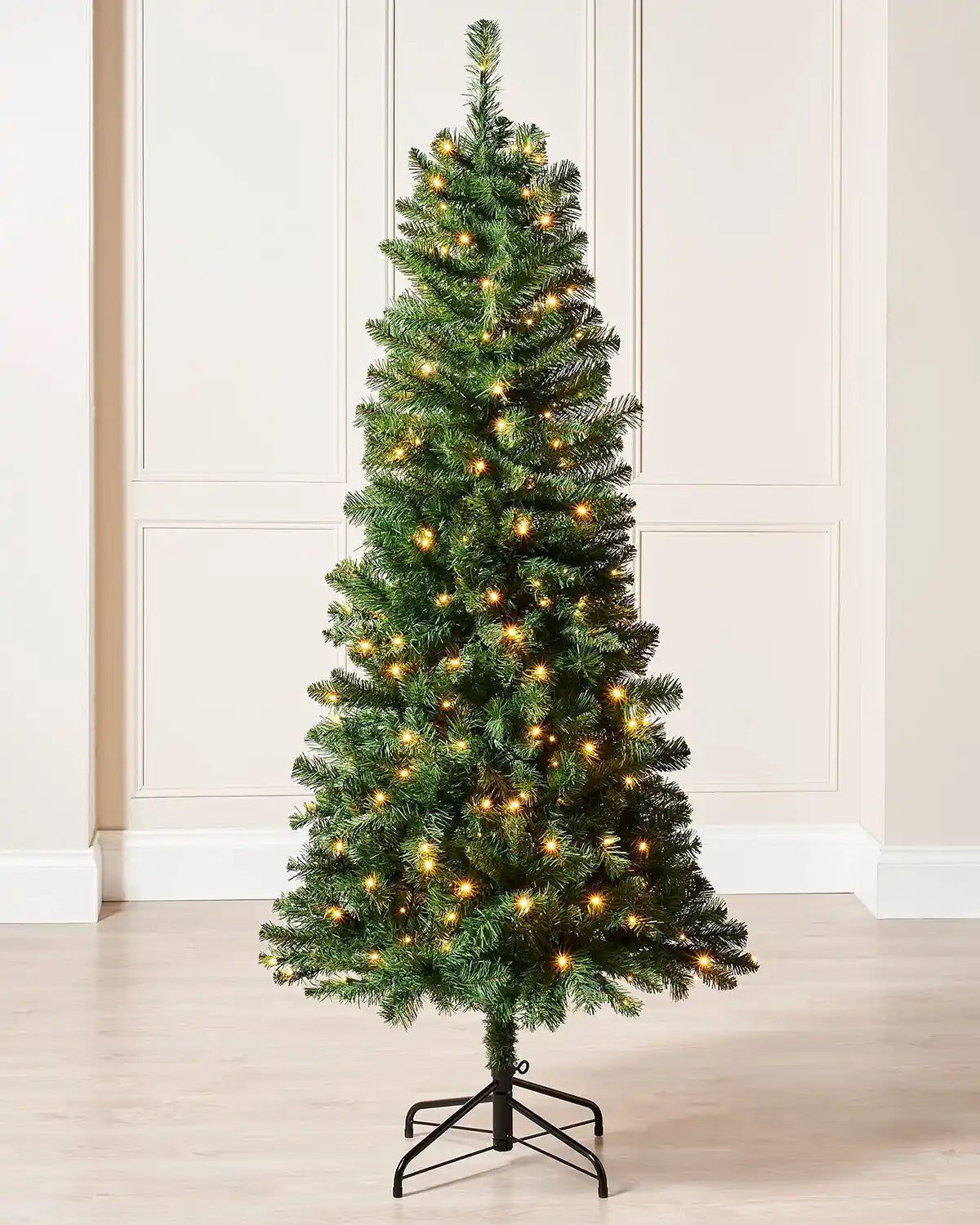 6ft slim Christmas tree displayed indoors with warm white LED lights and a narrow festive shape