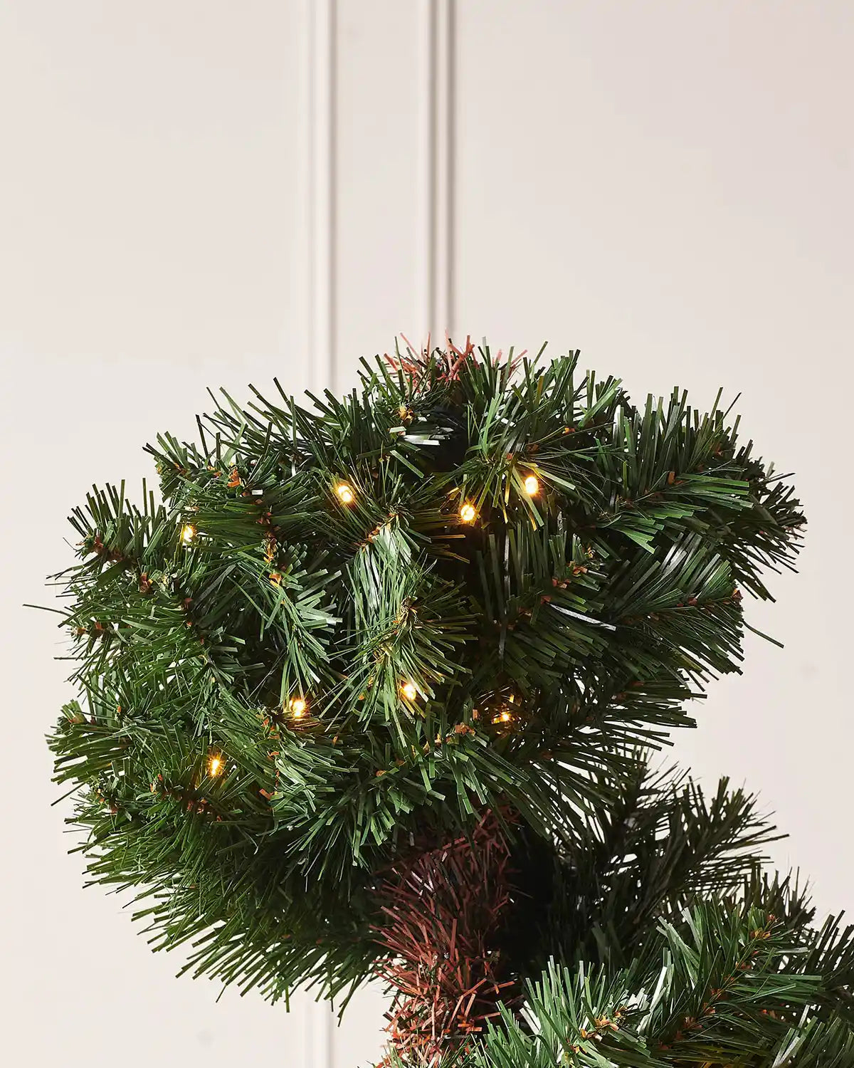 Top section of the pre-lit spiral Christmas tree with warm white lights