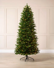 Full 7.5 ft pre-lit Woodland Pine artificial Christmas tree with 550 warm white LED lights.