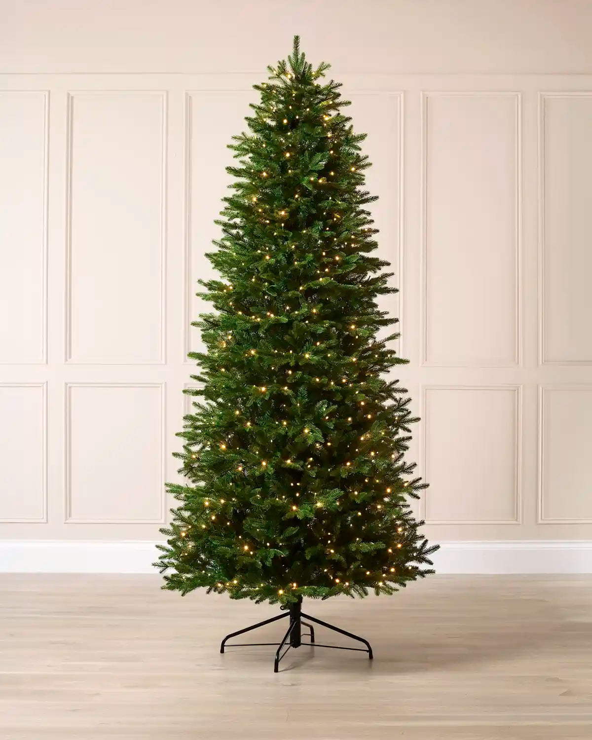 Full 7.5 ft pre-lit Woodland Pine artificial Christmas tree with 550 warm white LED lights.