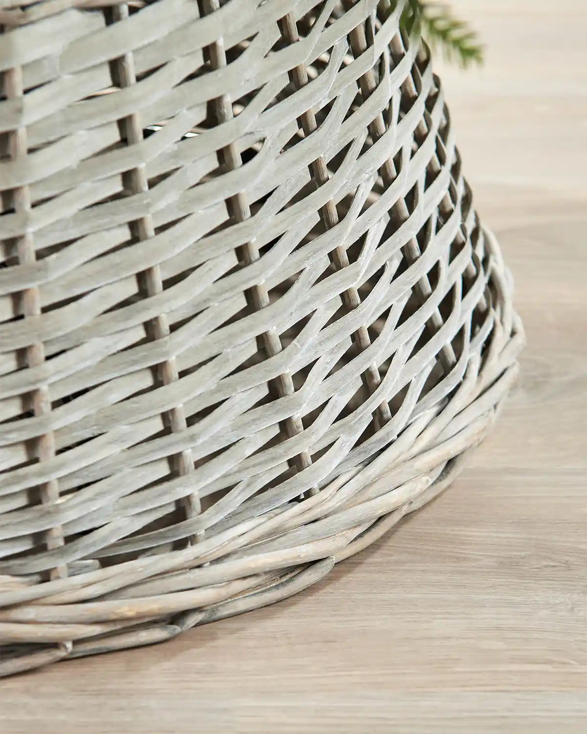 Detail view of the 70cm grey wicker tree collar with a soft grey woven rattan pattern and rounded lower edge.
