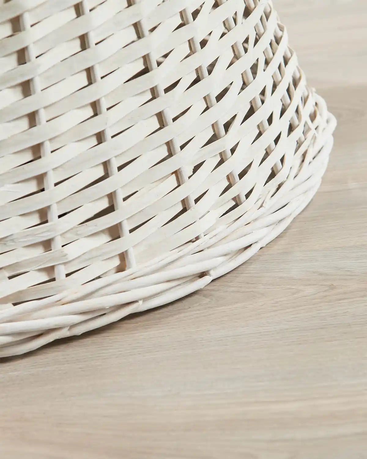 Detail view of the 70cm off-white wicker tree collar with a hand-woven rattan pattern and rounded lower edge.