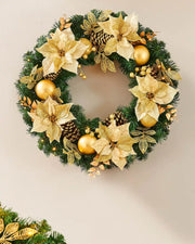 Extra thick cream and gold pre-lit Christmas wreath styled on a wall with warm white lights