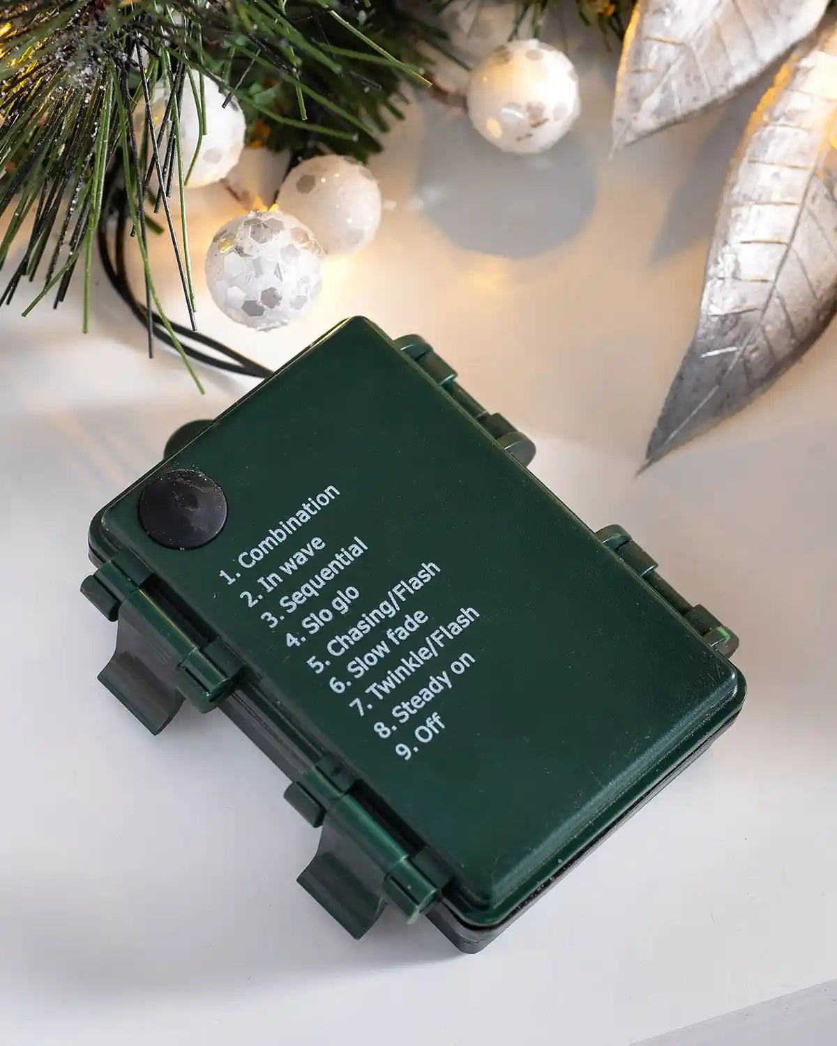 Close-up of the battery controller showing the light function settings for the pre-lit Christmas wreath