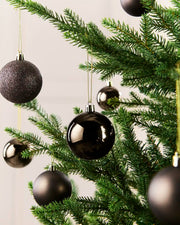 7 small Espresso coloured baubles hanging from a gold string on a Christmas tree against a cream background