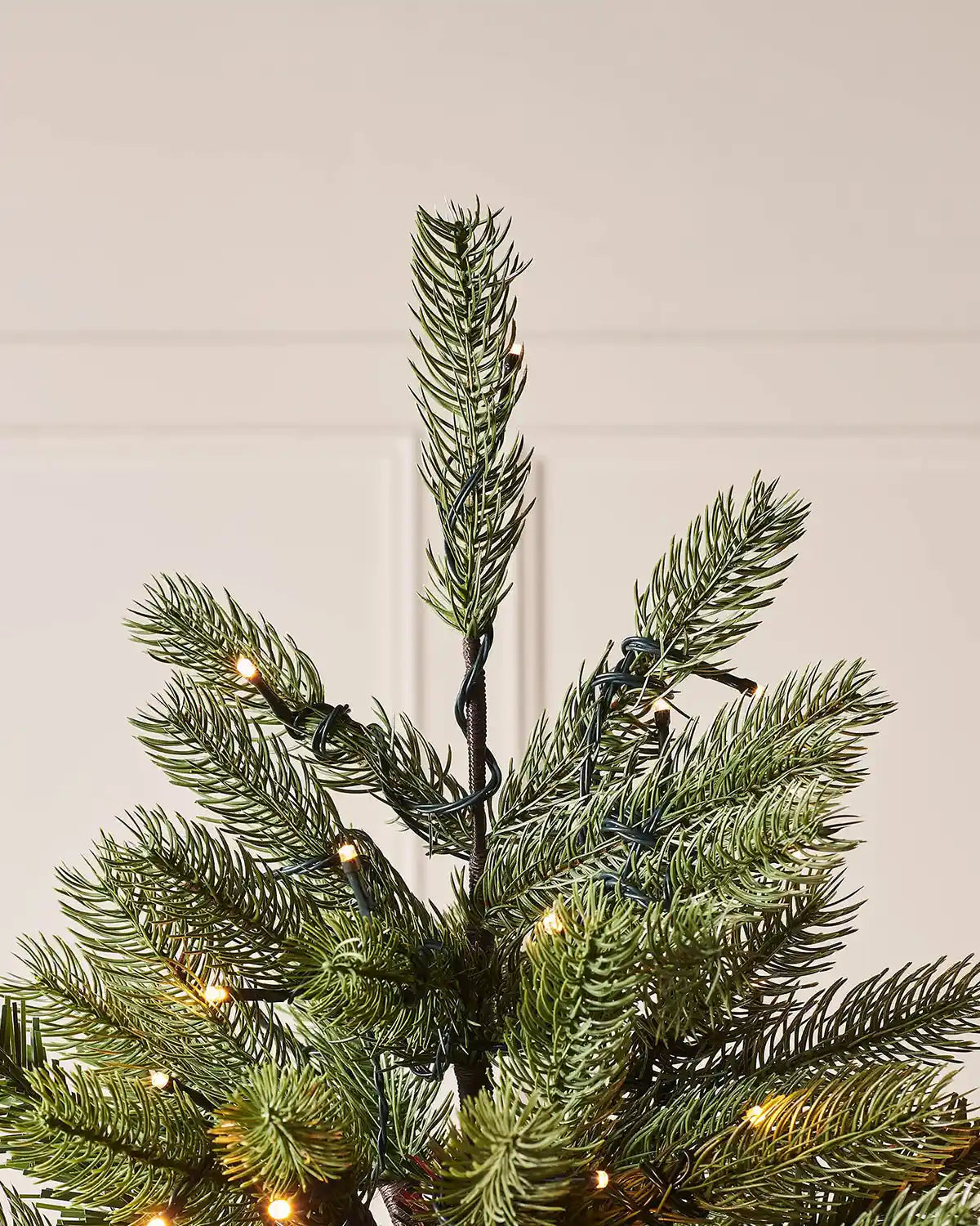 Top section of a 7 ft pre-lit Crawford pine Christmas tree with warm white lights