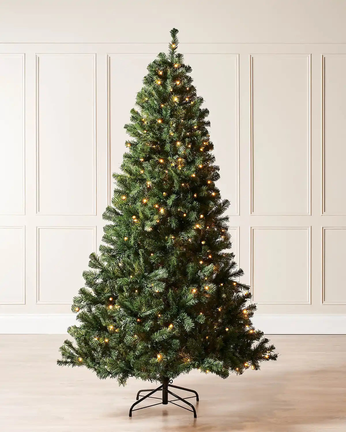 7 ft pre-lit emerald spruce Christmas tree with warm white LEDs and a metal tree stand