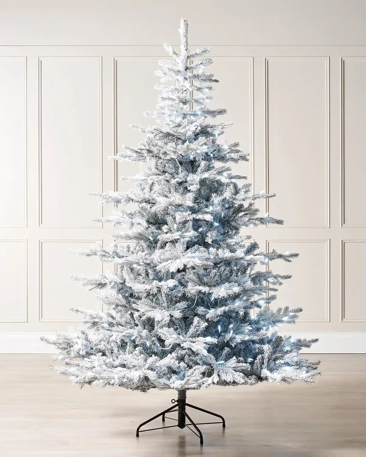 7ft snow flocked spruce Christmas tree displayed indoors with cool white LED lights and a full snowy shape