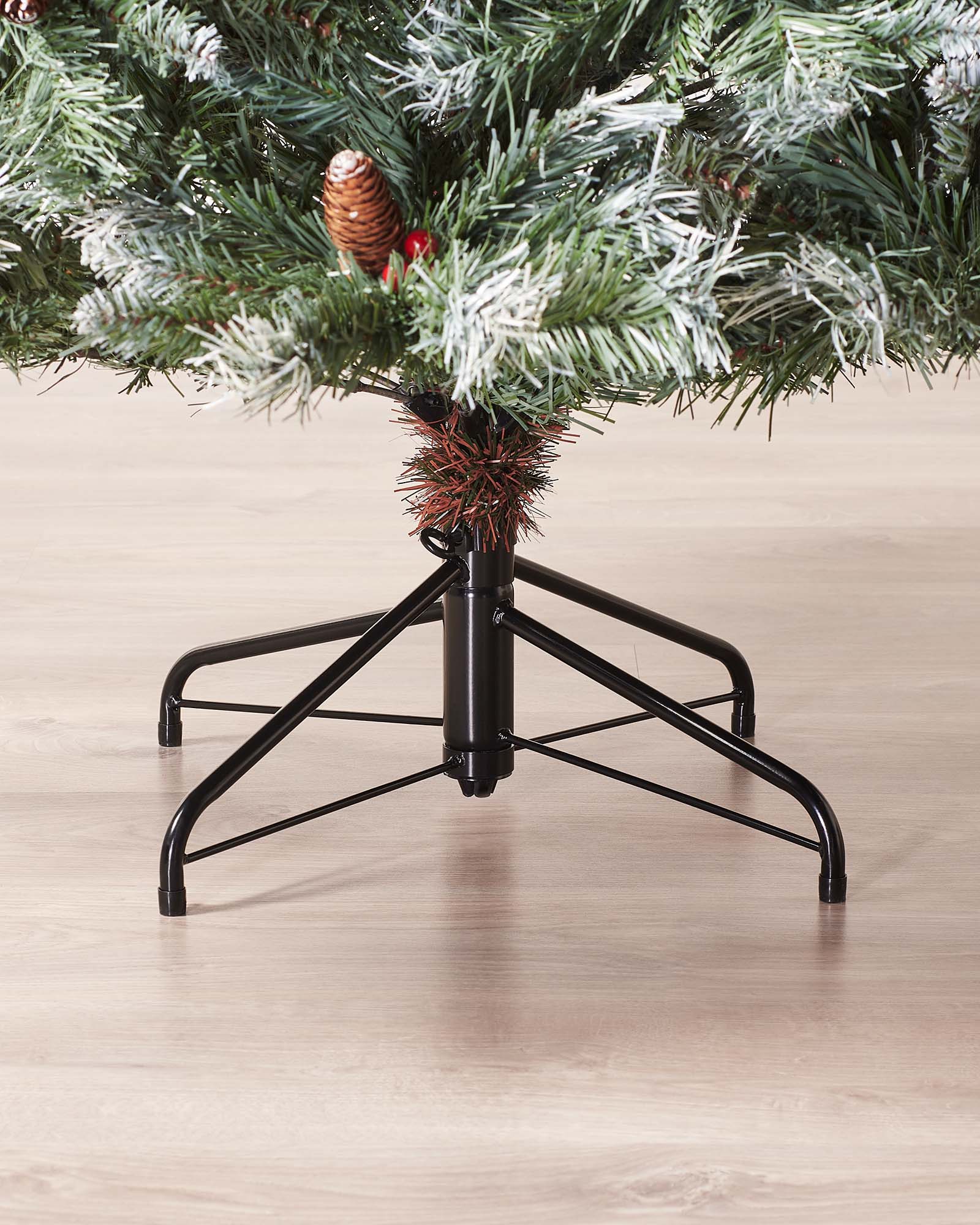 Close-up of the metal tree stand beneath a 7 ft Scandinavian blue spruce Christmas tree