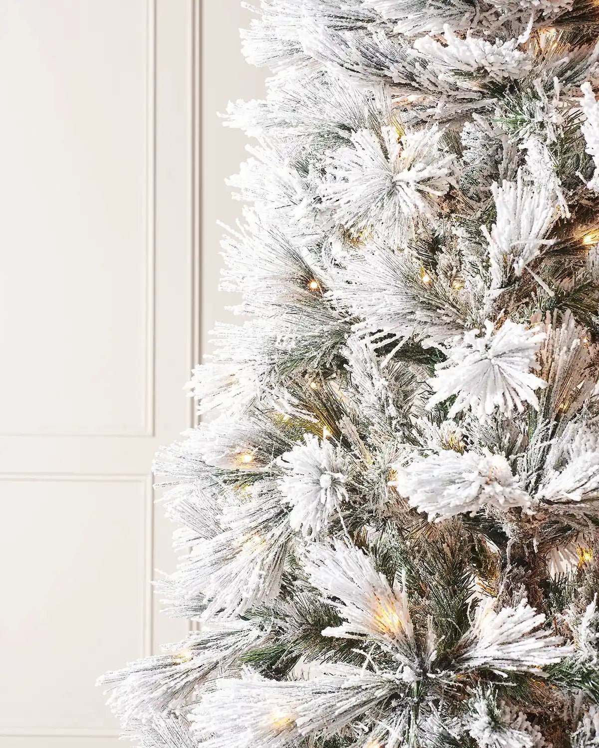Close-up of snow flocked branches on the 7 ft pine needle Christmas tree