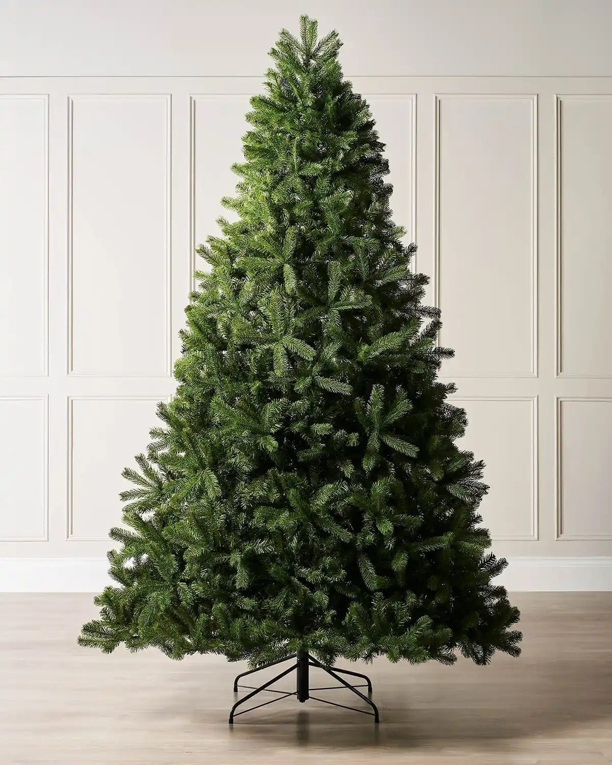 7ft Unlit Mixed Pine Christmas tree with a Black tree stand on a cream panel textured background 
