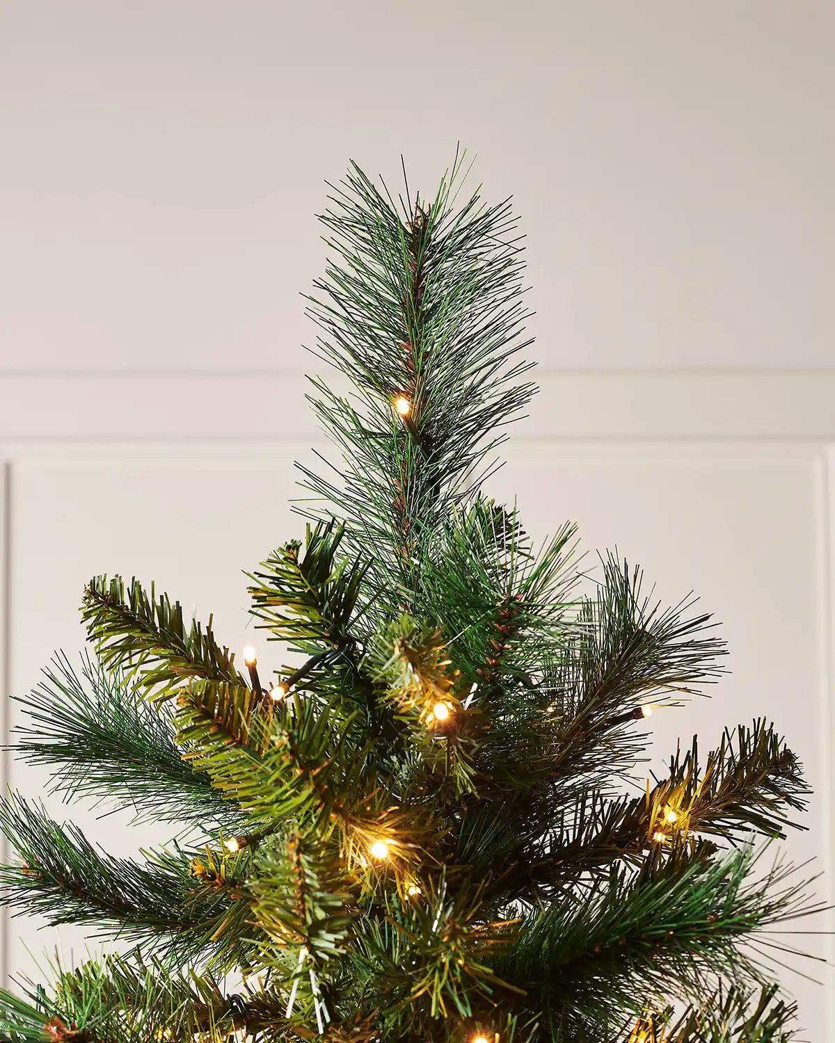 Close up of the top of 7ft Victorian Pine Christmas Tree with lights, PE and PVC tips.