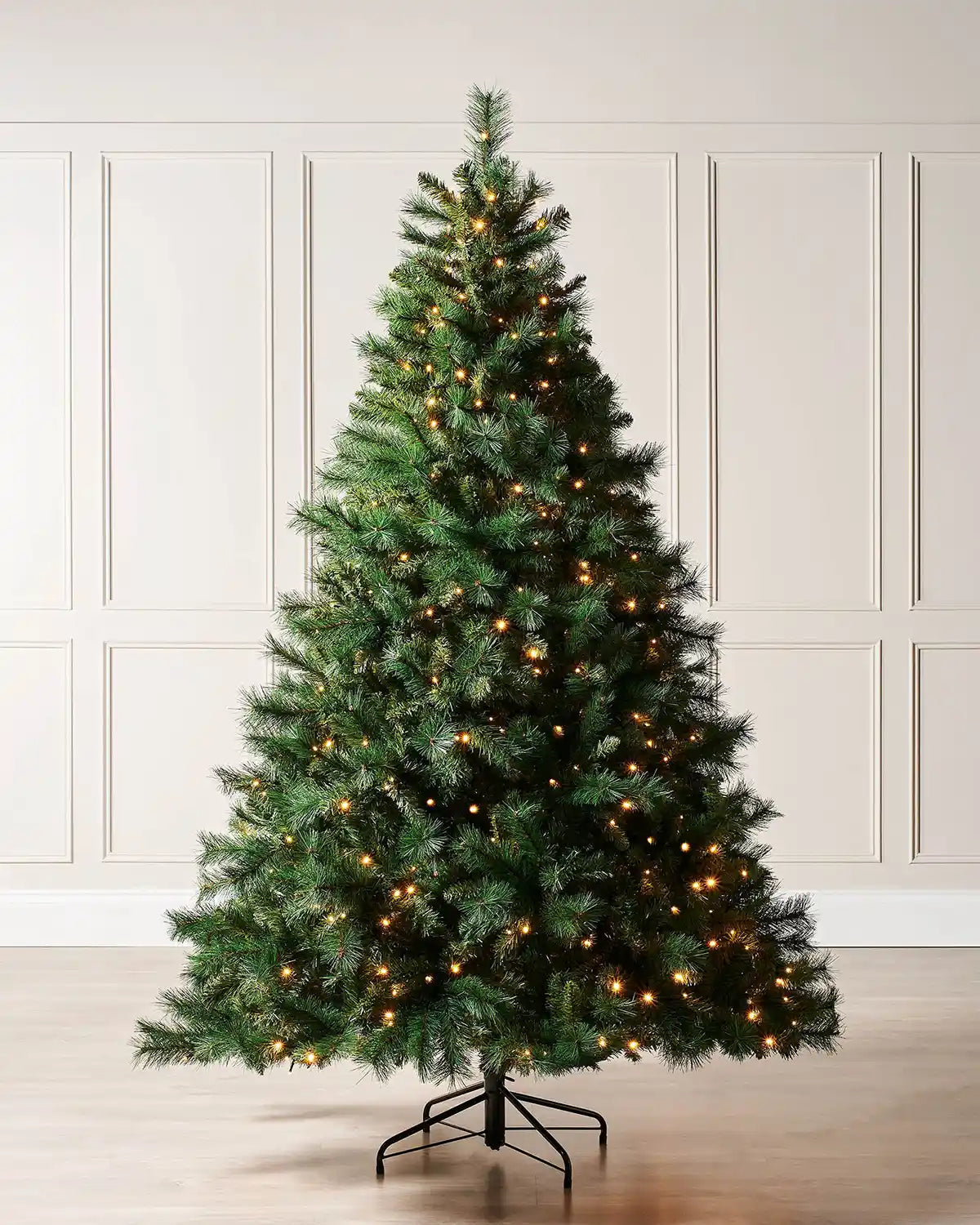7ft Victorian Pine Christmas tree with lights and Black tree stand with cream panel textured wallpaper
