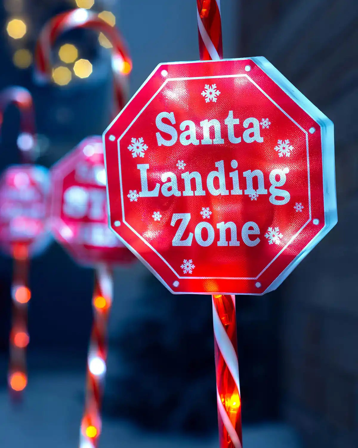 Close-up of illuminated Santa Landing Zone candy cane pathway stake light