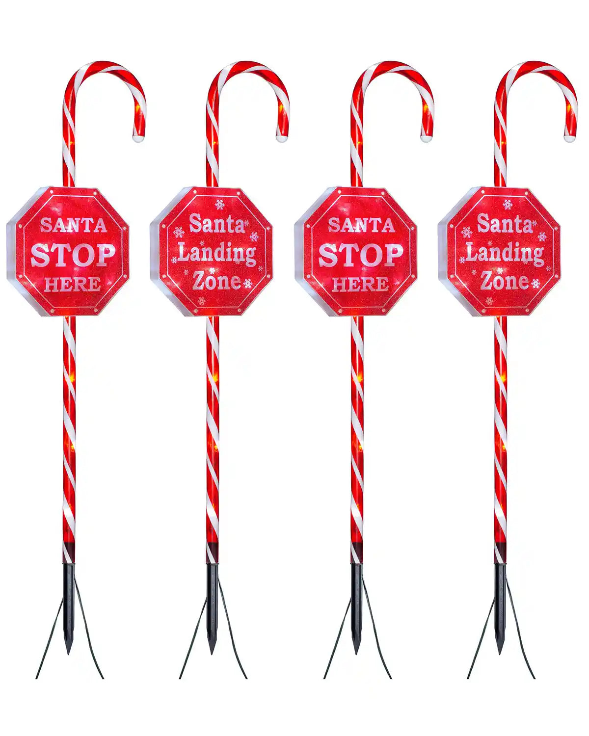 Set of 4 illuminated candy cane pathway stake lights with bright white LEDs on white background
