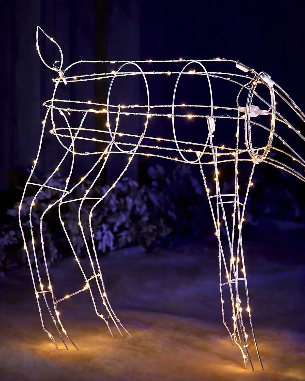 Side view of illuminated 3D grazing reindeer outdoor Christmas decoration