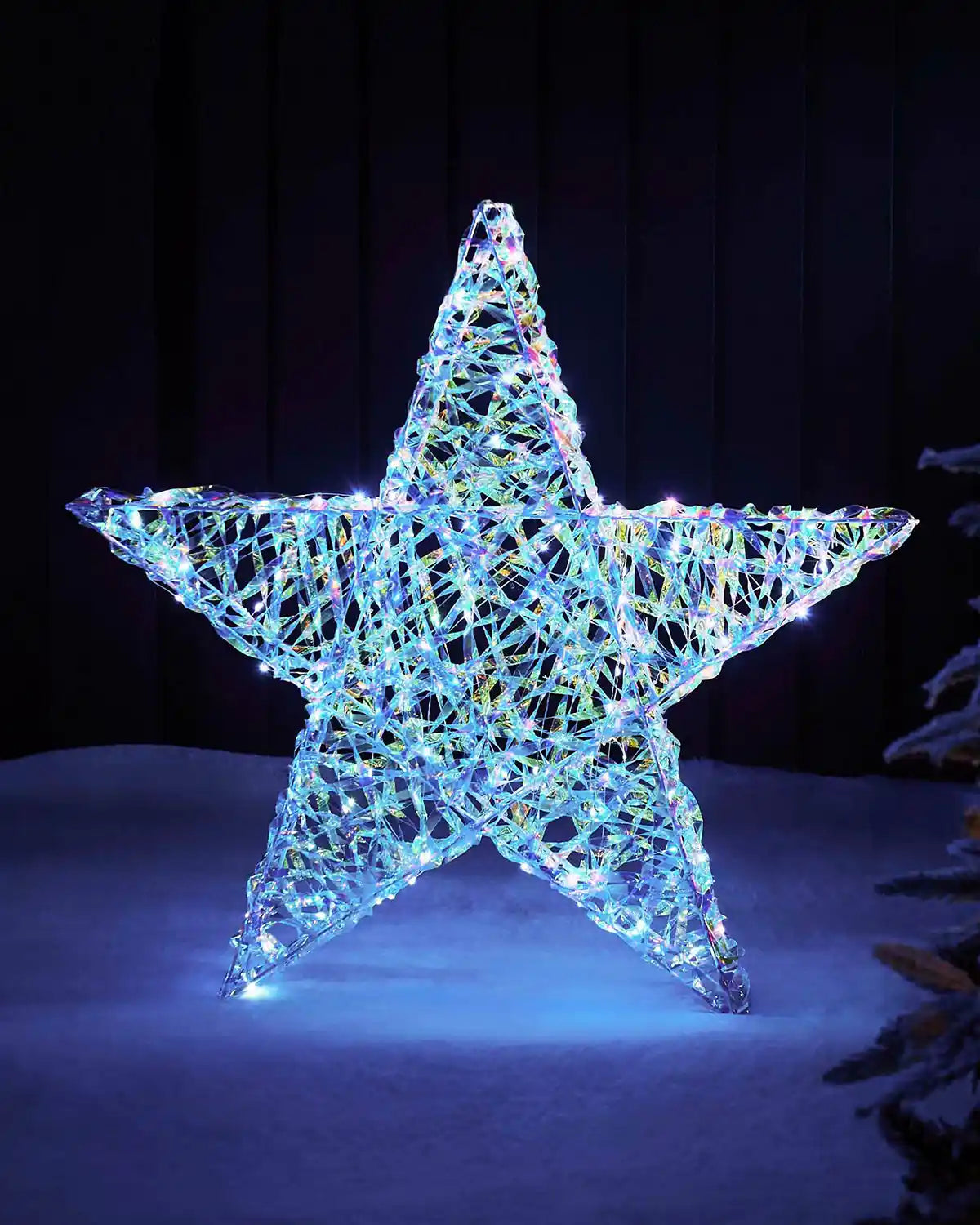 Full view of an 81cm iridescent star silhouette with cool white LED lights on a dark outdoor display.