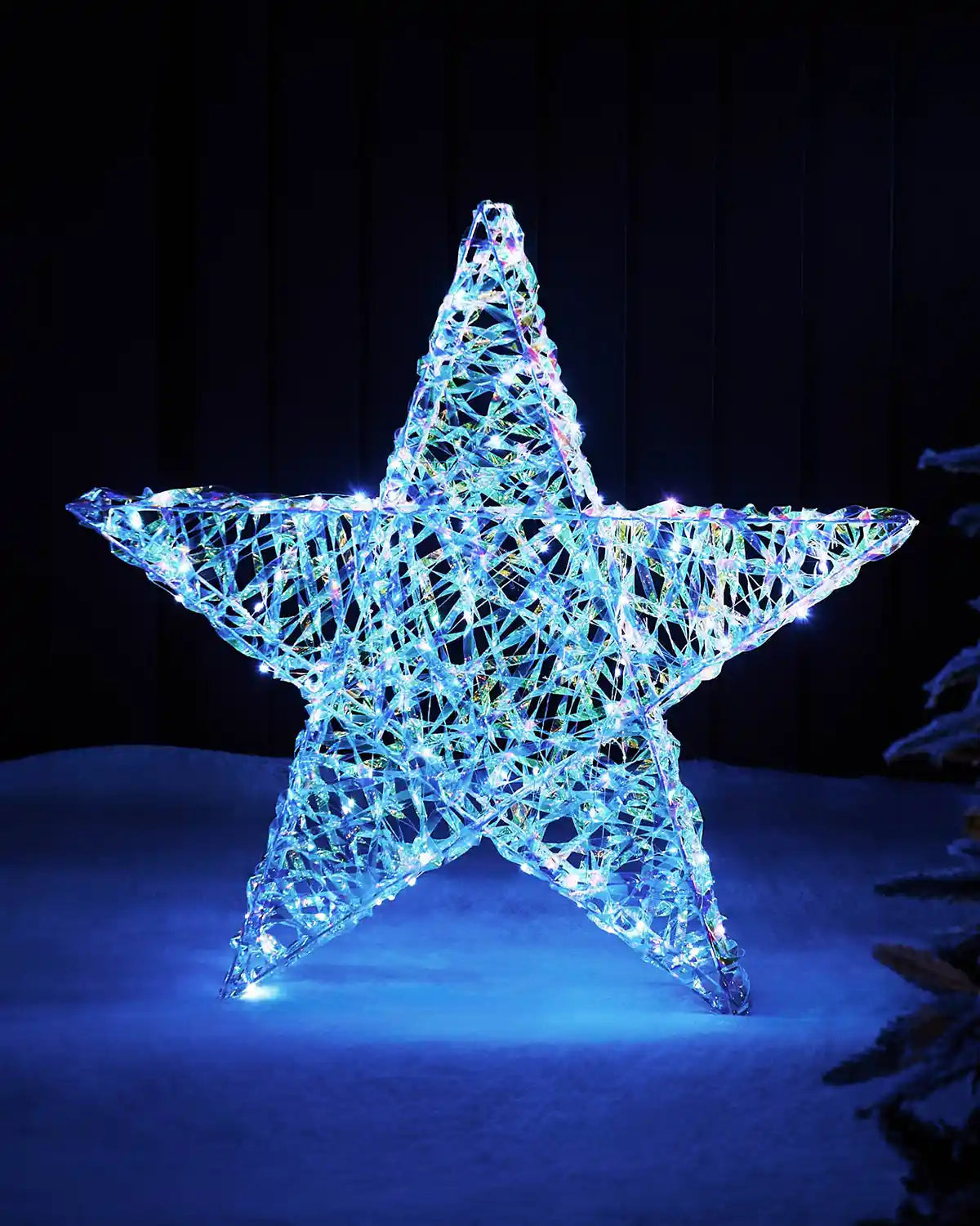 81cm pre-lit iridescent star silhouette glowing with white LEDs in an outdoor festive display.