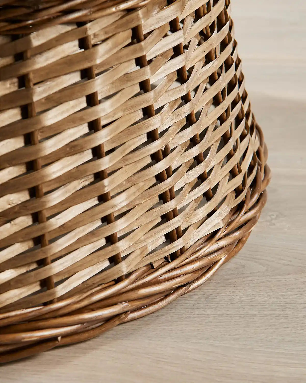 Detail view of the 85cm brown wicker tree collar with a hand-woven rattan pattern and darker rounded lower edge.