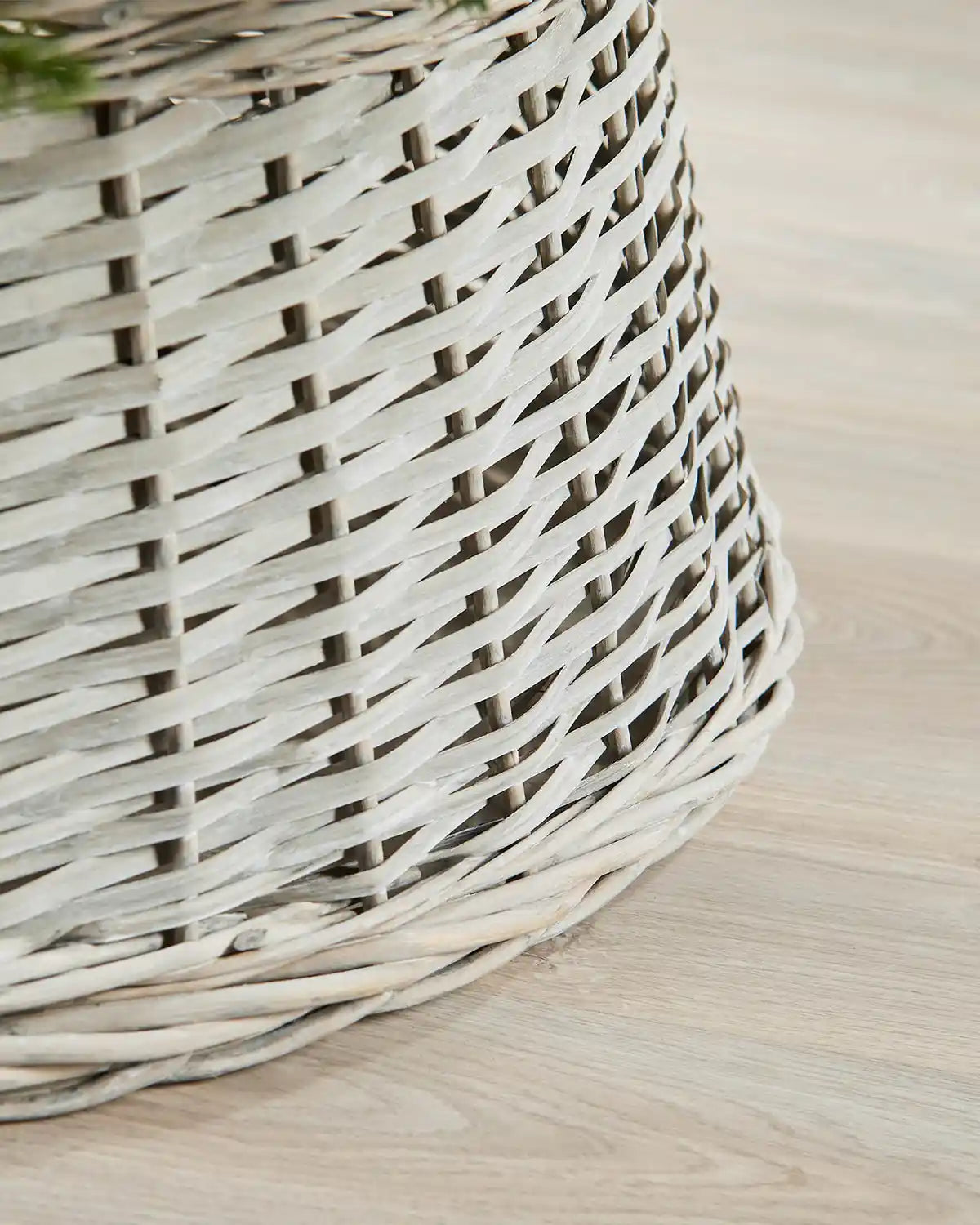 Detail view of the 85cm grey wicker tree collar with a hand-woven rattan pattern and rounded lower edge.