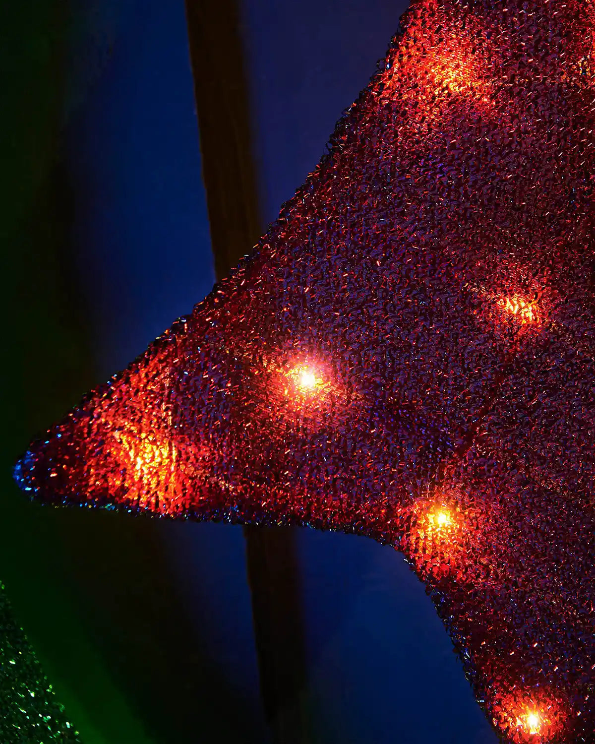 Detail of the red bow section with warm white LEDs on the 3D wreath silhouette.