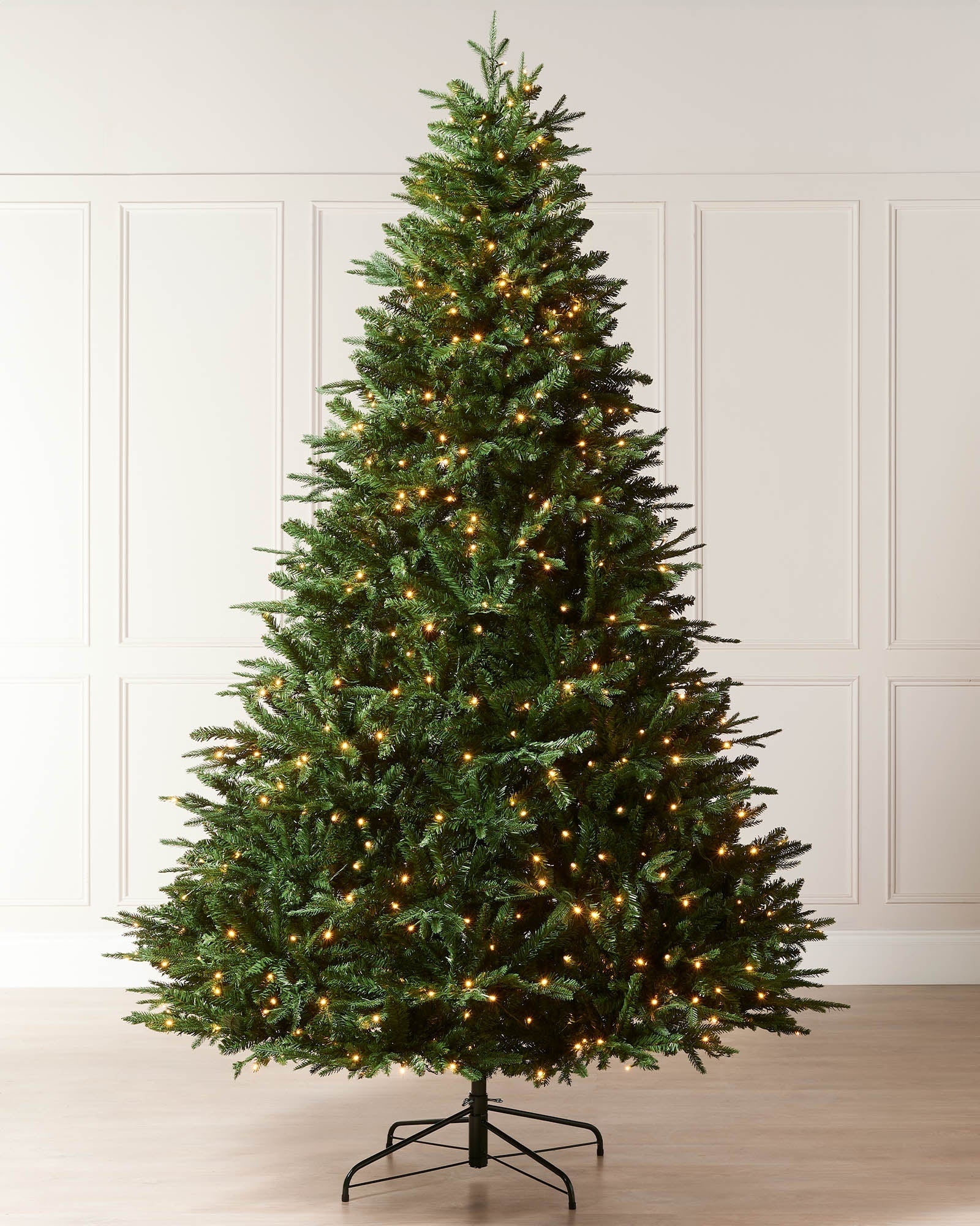 8ft pre-lit green Grand Alaskan Fir Christmas tree with warm white lights displayed indoors