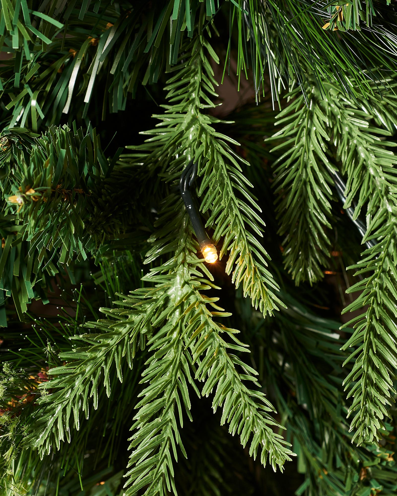 Detail of warm white LED lights nestled among mixed PE and PVC branches on the 8ft Victorian Christmas tree.