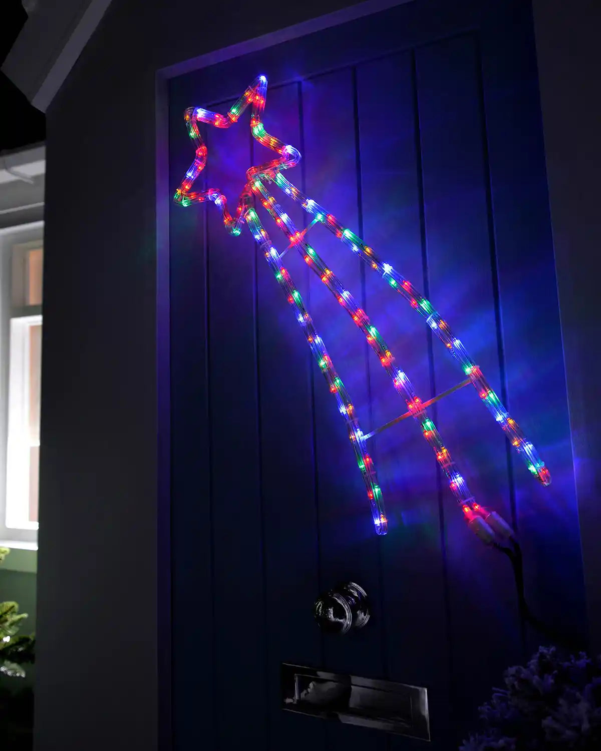 Multi-coloured shooting star rope light displayed on a front door