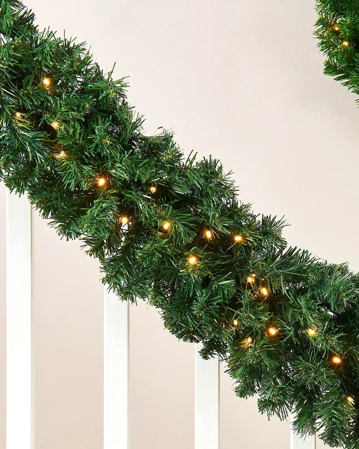 Close-up of pre-lit extra thick pine Christmas garland with warm white LED lights