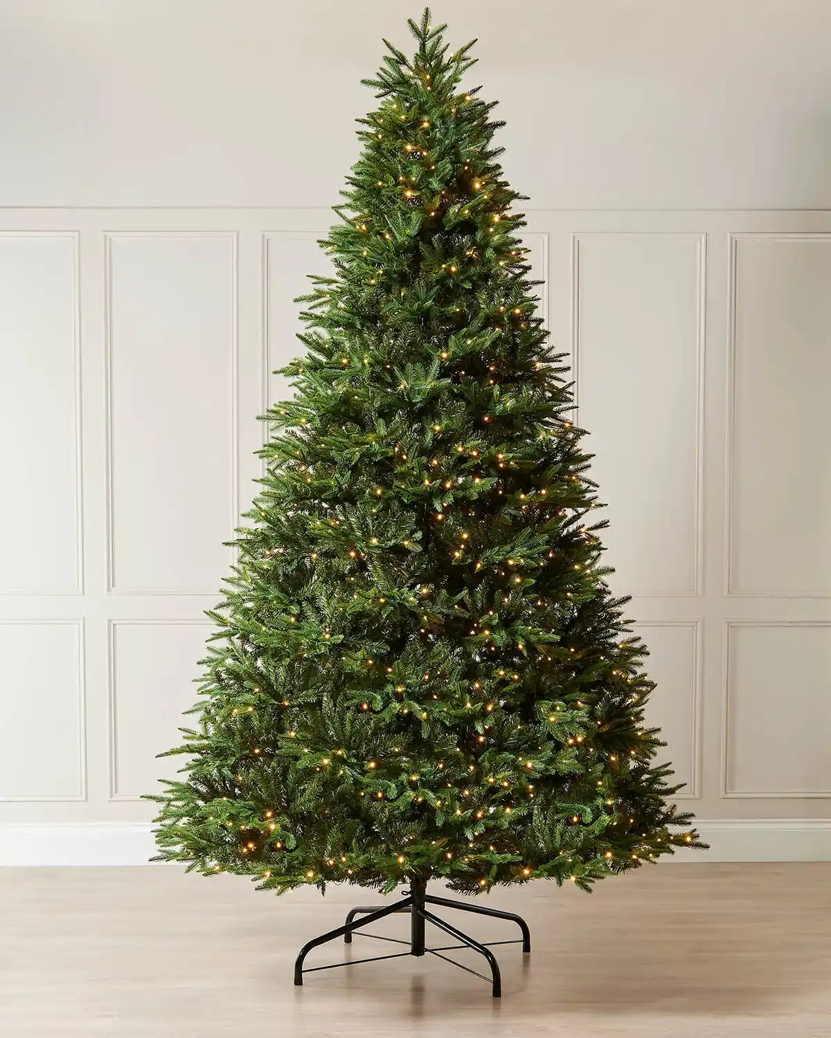 9ft pre-lit Royal Fir Christmas tree with a full green shape, warm white LEDs and metal tree stand.
