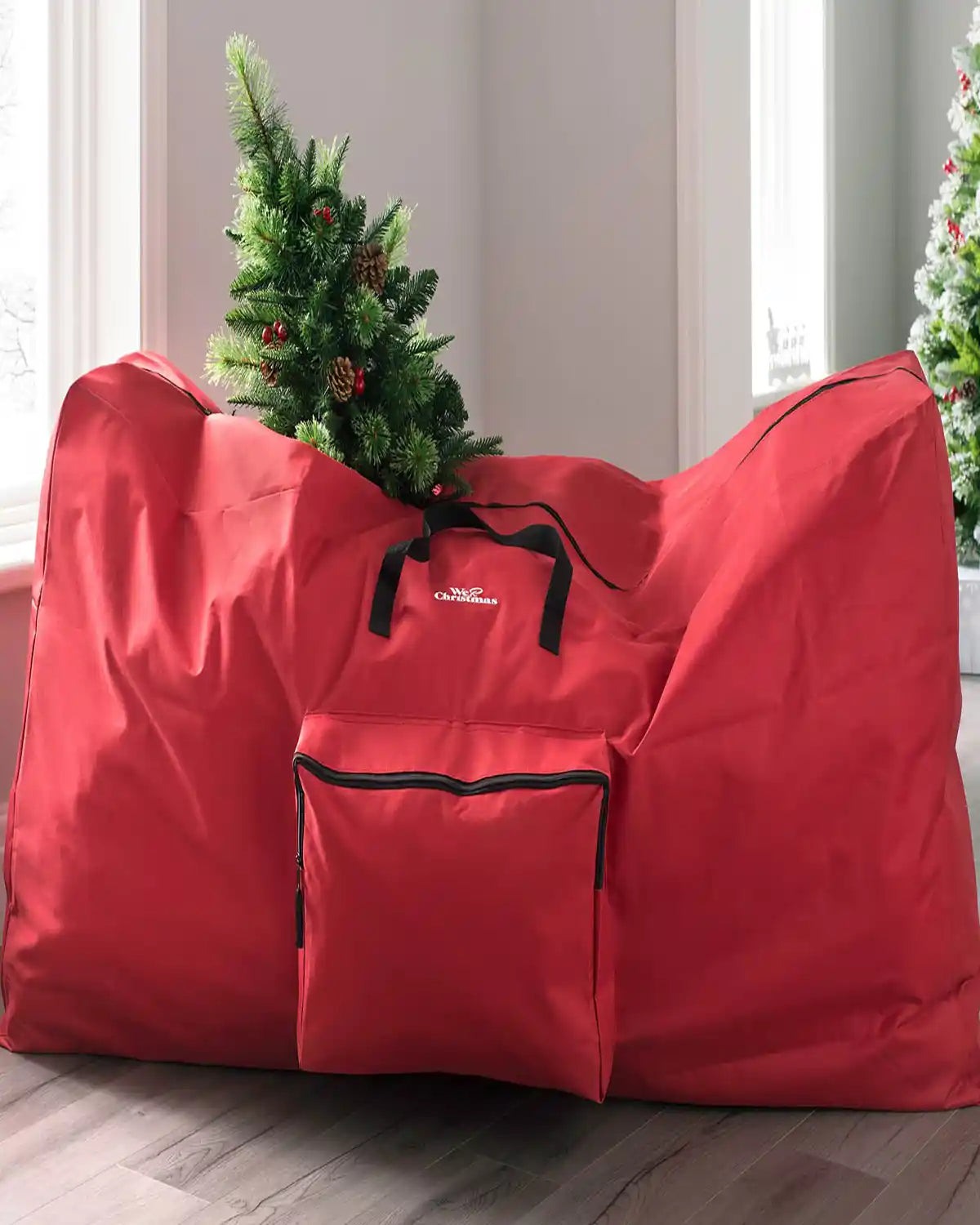 Red Christmas tree storage bag with an artificial Christmas tree inside