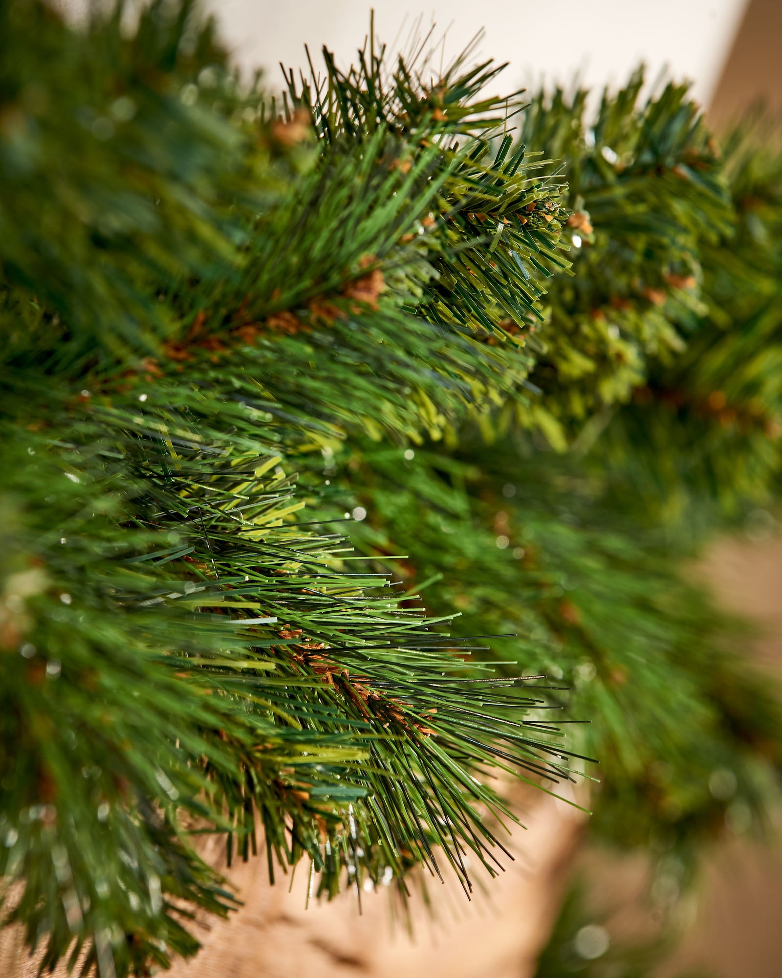 Close-up of dense green Victorian pine garland branches with mixed needle textures