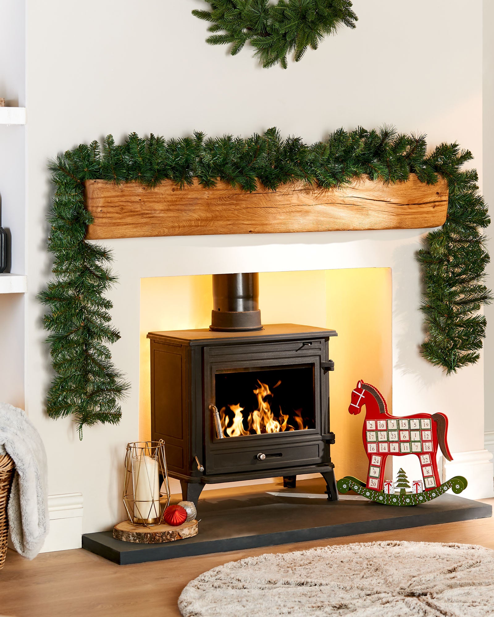 9 ft Victorian pine garland displayed around a fireplace mantelpiece in a festive living room