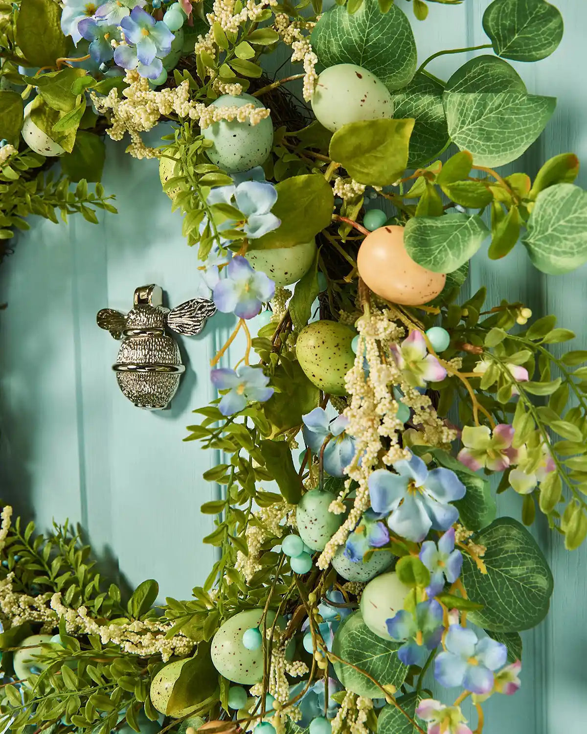 A Blue 28 inch Artificial Floral Egg Spring Wreath close up shot.