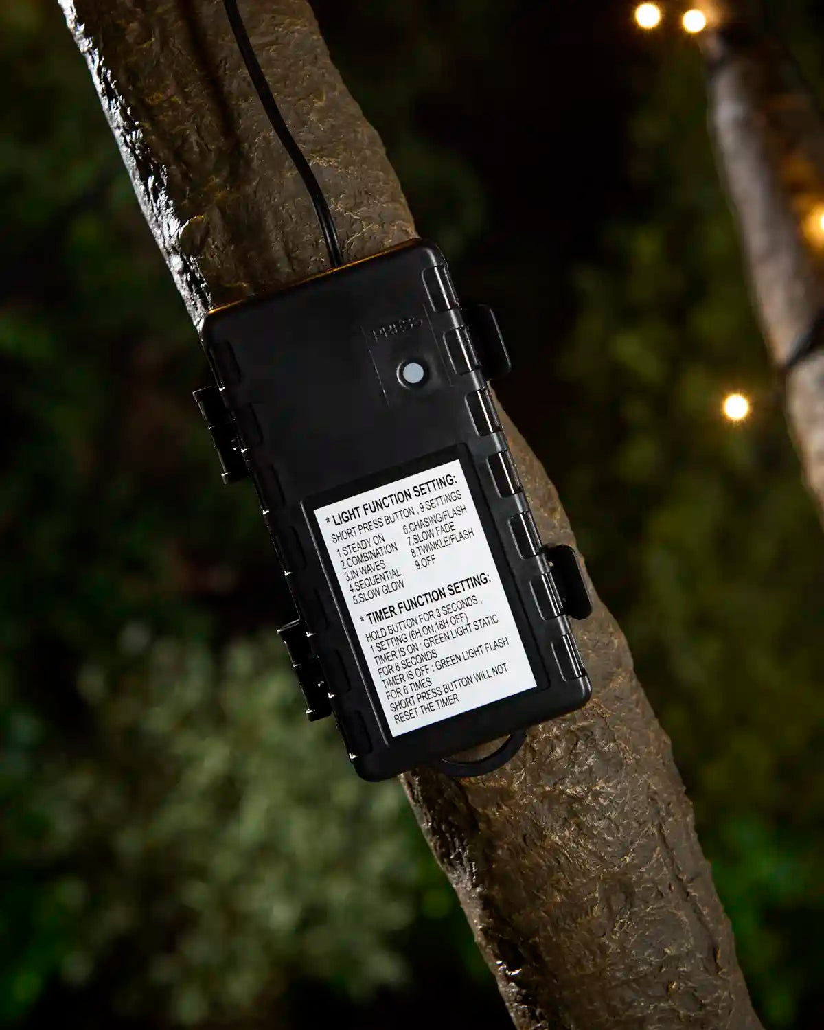 Black 3C Battery Box attached to tree with blurred garden background